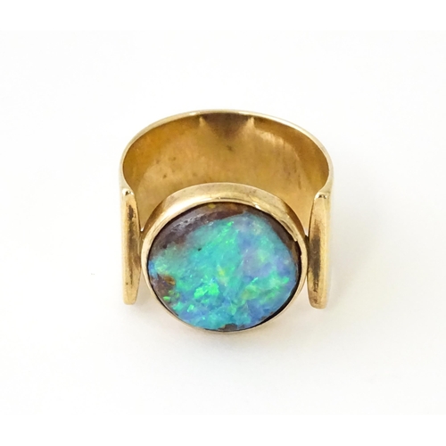 633 - An Arts & Crafts yellow metal ring set with opal cabochon. Ring size approx. H 1/2