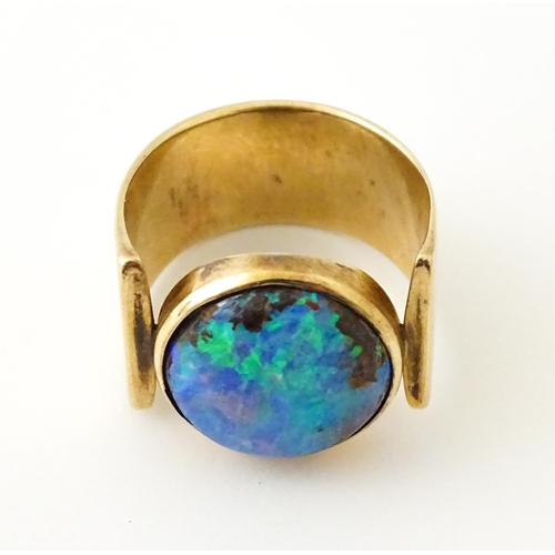 633 - An Arts & Crafts yellow metal ring set with opal cabochon. Ring size approx. H 1/2