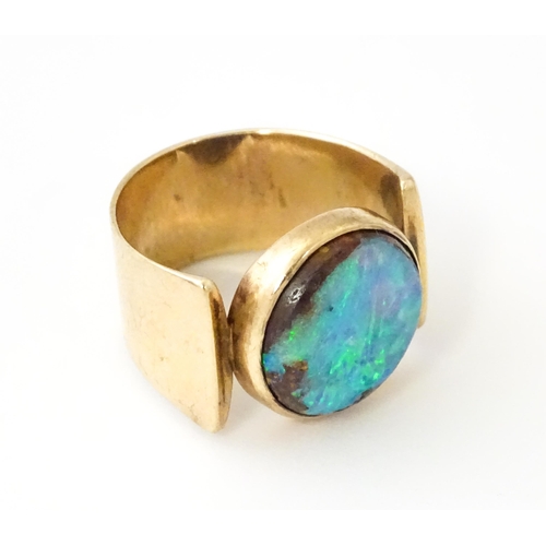 633 - An Arts & Crafts yellow metal ring set with opal cabochon. Ring size approx. H 1/2