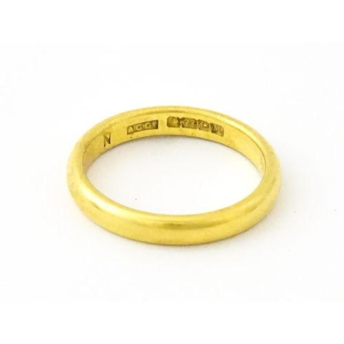 634 - A 22ct gold ring / band. Ring size approx. M 1/2