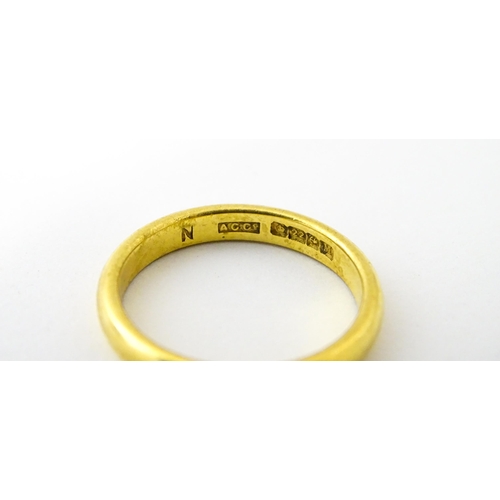 634 - A 22ct gold ring / band. Ring size approx. M 1/2