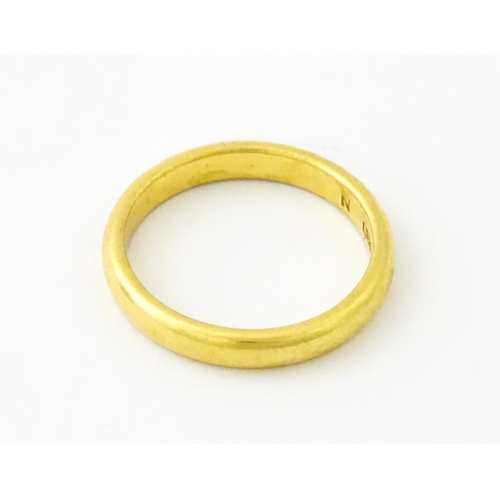 634 - A 22ct gold ring / band. Ring size approx. M 1/2