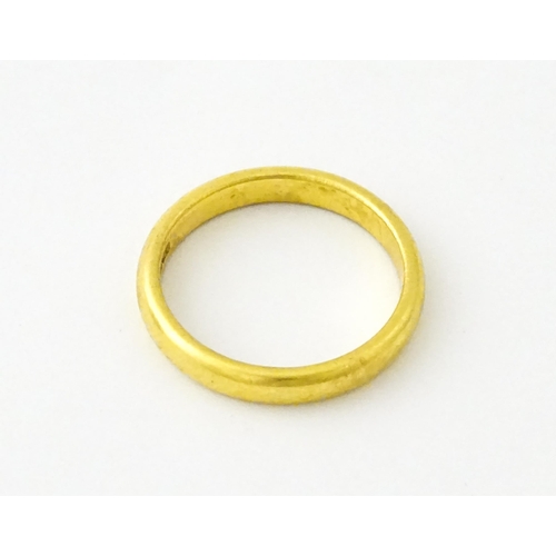 634 - A 22ct gold ring / band. Ring size approx. M 1/2