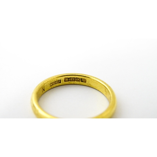 634 - A 22ct gold ring / band. Ring size approx. M 1/2