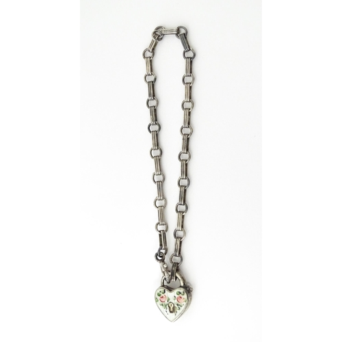 641 - A silver chain bracelet with padlock formed clasp having guilloche enamel and floral detail. Approx.... 