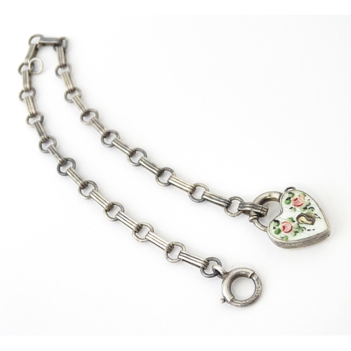 641 - A silver chain bracelet with padlock formed clasp having guilloche enamel and floral detail. Approx.... 