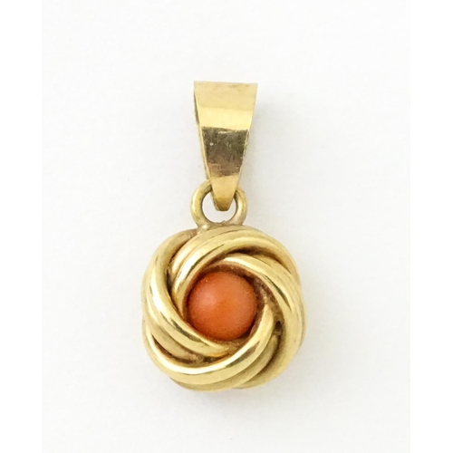 646 - A 9ct gold pendant set with central coral cabochon. Approx. 3/4