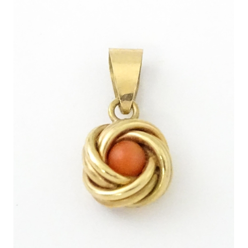 646 - A 9ct gold pendant set with central coral cabochon. Approx. 3/4