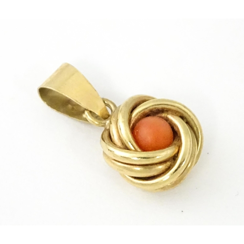 646 - A 9ct gold pendant set with central coral cabochon. Approx. 3/4