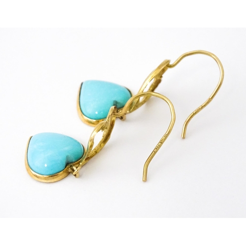 648 - A pair of 18ct gold drop earrings with heart detail, and set with turquoise coloured cabochon of hea... 