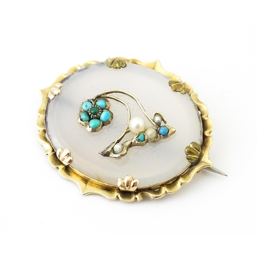 649 - A late 19th / early 20thC brooch set with central chalcedony panel with turquoise and seed pearl det... 