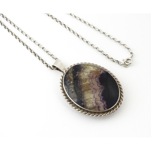 651 - A silver pendant set with Blue John hallmarked Sheffield 1975, maker Ralph Weston, on a silver chain... 