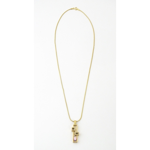 653 - A 9ct gold pendant on chain, the Modernist pendant set with pink stone, by Carrick Jewellery Ltd. Pe... 