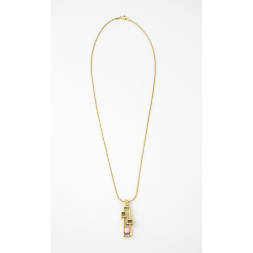 653 - A 9ct gold pendant on chain, the Modernist pendant set with pink stone, by Carrick Jewellery Ltd. Pe... 