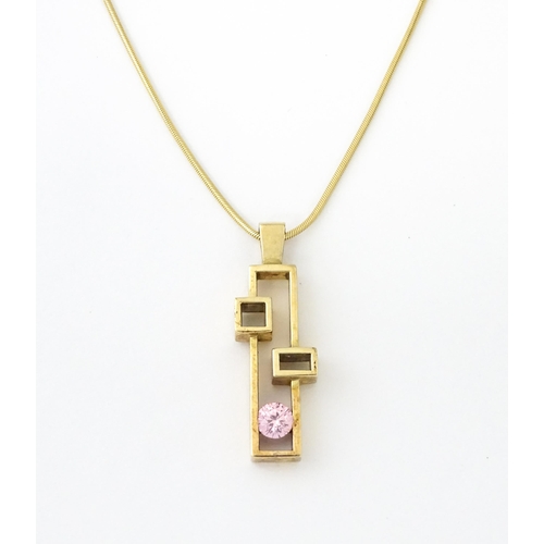 653 - A 9ct gold pendant on chain, the Modernist pendant set with pink stone, by Carrick Jewellery Ltd. Pe... 