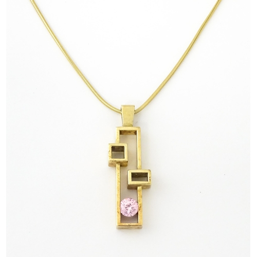 653 - A 9ct gold pendant on chain, the Modernist pendant set with pink stone, by Carrick Jewellery Ltd. Pe... 