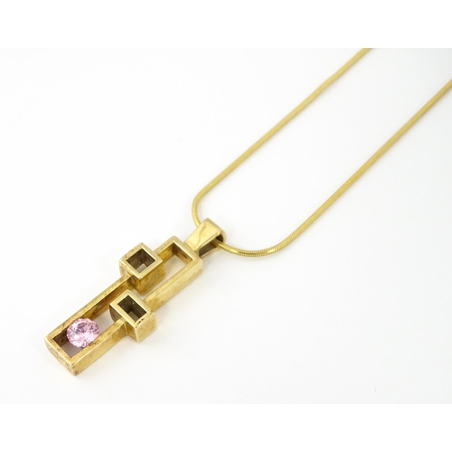 653 - A 9ct gold pendant on chain, the Modernist pendant set with pink stone, by Carrick Jewellery Ltd. Pe... 