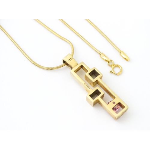 653 - A 9ct gold pendant on chain, the Modernist pendant set with pink stone, by Carrick Jewellery Ltd. Pe... 