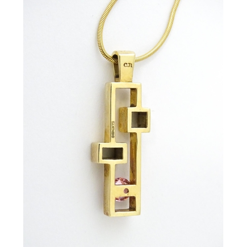 653 - A 9ct gold pendant on chain, the Modernist pendant set with pink stone, by Carrick Jewellery Ltd. Pe... 