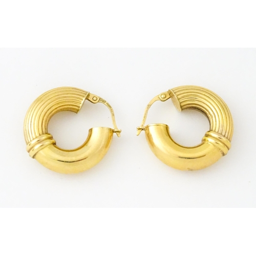 654 - A pair of 9ct gold hoop earrings. Approx. 3/4