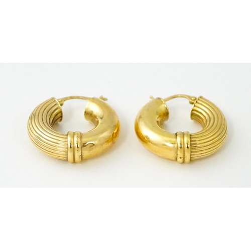 654 - A pair of 9ct gold hoop earrings. Approx. 3/4