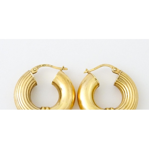 654 - A pair of 9ct gold hoop earrings. Approx. 3/4