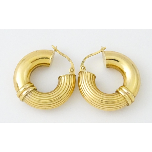 654 - A pair of 9ct gold hoop earrings. Approx. 3/4