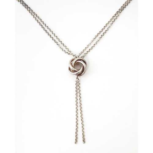 665 - A silver chain necklace with knot detail. Approx. 20