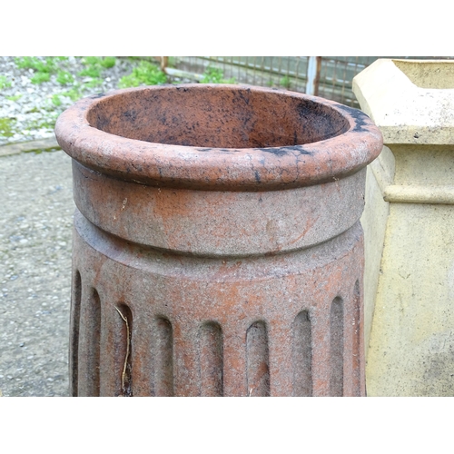 1334 - Four chimney pots, to include two terracotta and two stoneware examples, the largest approx 31