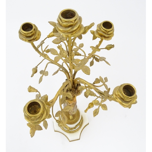 1396 - A late 19thC French white marble ormolu clock garniture, the clock formed as three ormolu putti hold... 