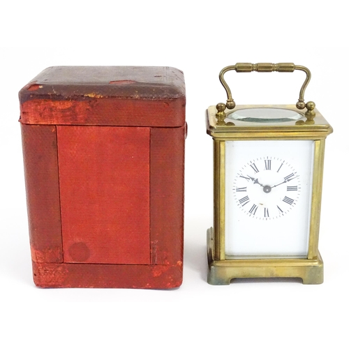 1397 - A brass carriage clock with travel case. The clock standing approx 6