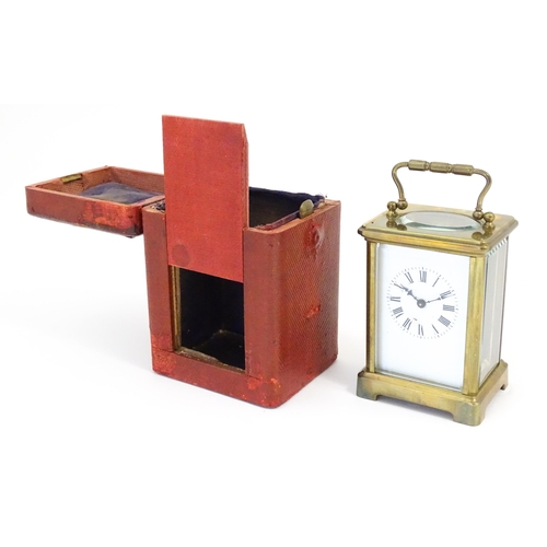 1397 - A brass carriage clock with travel case. The clock standing approx 6