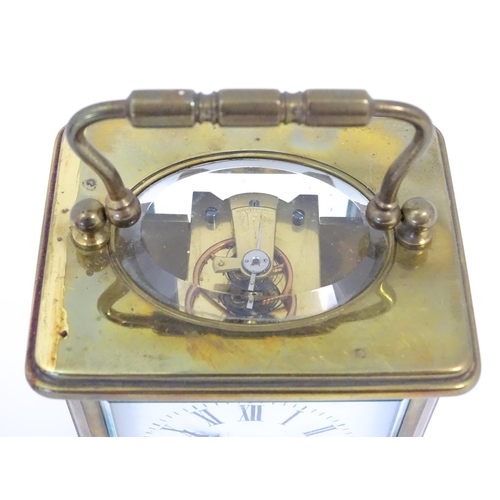 1397 - A brass carriage clock with travel case. The clock standing approx 6