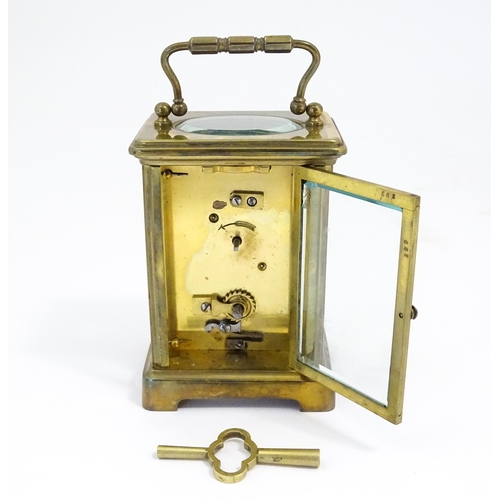 1397 - A brass carriage clock with travel case. The clock standing approx 6