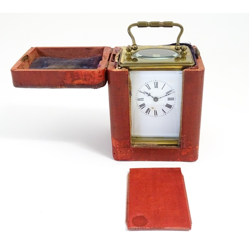 1397 - A brass carriage clock with travel case. The clock standing approx 6