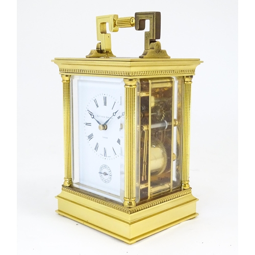 1402 - A brass cased repeater carriage clock,  the white enamel dial with Roman numerals and signed Matthew... 