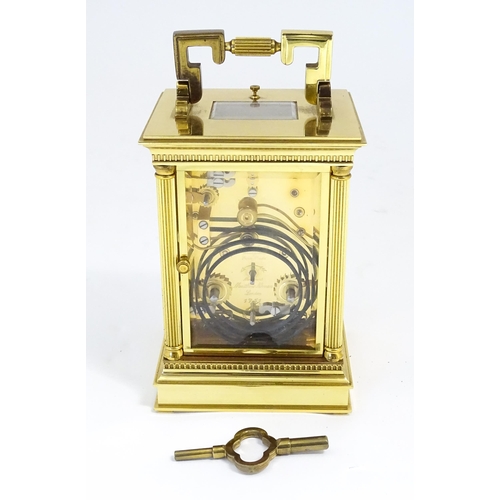 1402 - A brass cased repeater carriage clock,  the white enamel dial with Roman numerals and signed Matthew... 