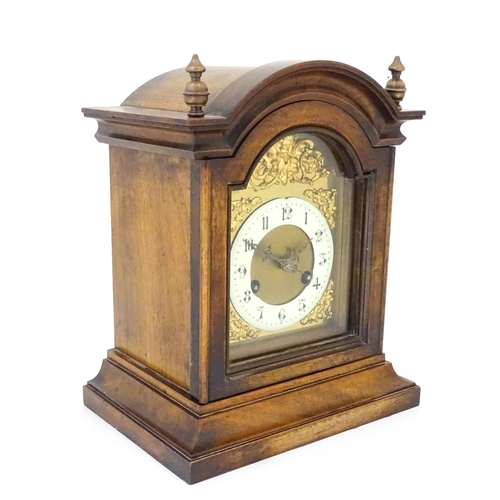 1404 - An early 20thC Junghans walnut cased mantle clock with enamel Arabic chapter ring,  the 8-day moveme... 