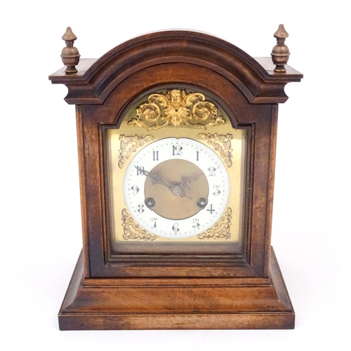 1404 - An early 20thC Junghans walnut cased mantle clock with enamel Arabic chapter ring,  the 8-day moveme... 