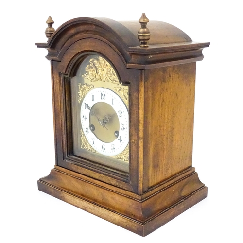 1404 - An early 20thC Junghans walnut cased mantle clock with enamel Arabic chapter ring,  the 8-day moveme... 