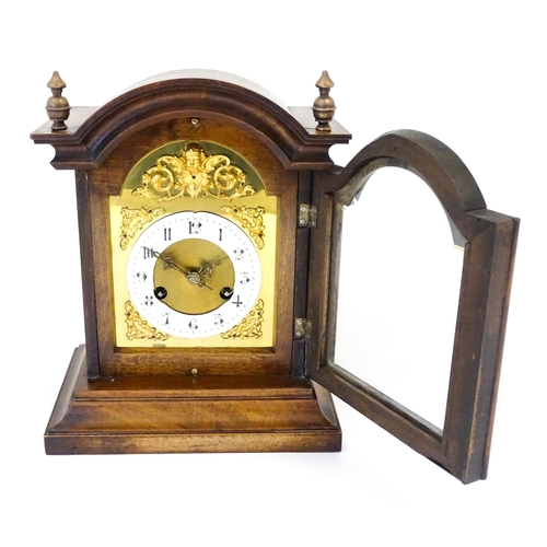 1404 - An early 20thC Junghans walnut cased mantle clock with enamel Arabic chapter ring,  the 8-day moveme... 