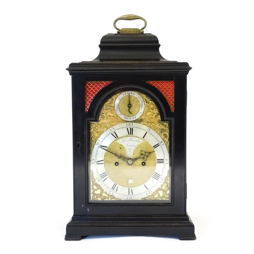 1405 - A late 18thC / early 19thC ebonised bracket clock. The silvered dial with strike/silent to the arch,... 