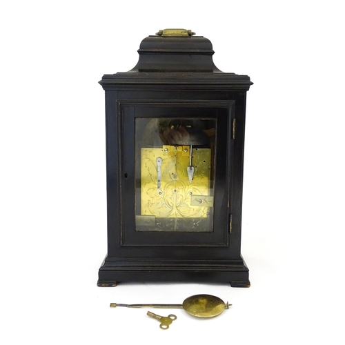 1405 - A late 18thC / early 19thC ebonised bracket clock. The silvered dial with strike/silent to the arch,... 