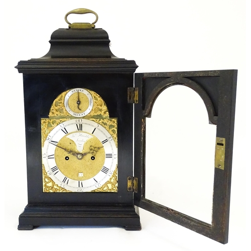 1405 - A late 18thC / early 19thC ebonised bracket clock. The silvered dial with strike/silent to the arch,... 