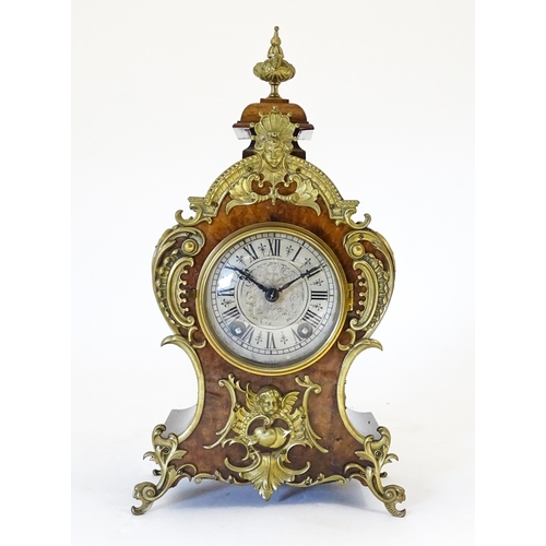 1410 - A late 19thC / early 20thC German walnut mantle clock with silvered dial having Roman chapter ring, ... 