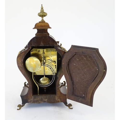 1410 - A late 19thC / early 20thC German walnut mantle clock with silvered dial having Roman chapter ring, ... 