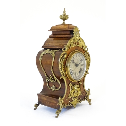 1410 - A late 19thC / early 20thC German walnut mantle clock with silvered dial having Roman chapter ring, ... 