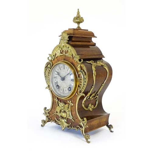 1410 - A late 19thC / early 20thC German walnut mantle clock with silvered dial having Roman chapter ring, ... 