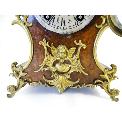 1410 - A late 19thC / early 20thC German walnut mantle clock with silvered dial having Roman chapter ring, ... 