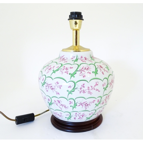 1418 - An Italian table lamp the ceramic body with pink and green floral and foliate detail. Approx. 15